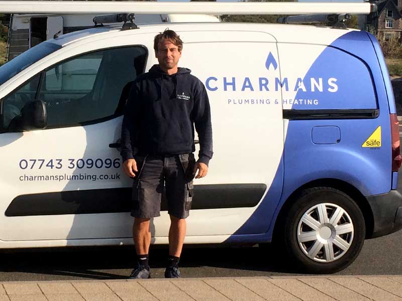 Wayne Charman posing next to his Van