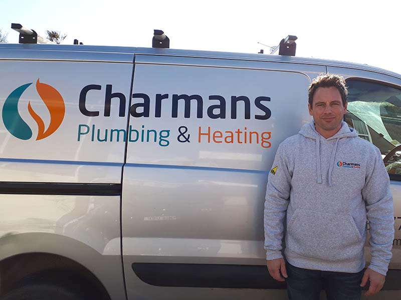 Wayne Charman posing next to his Van